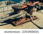 Small photo of Cleat Nautical Cleats Rope Tied Rope Holding a Boat at Harbor Marina Dock - Fishing Industry