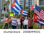 Small photo of Sarasota, Florida, USA - July 14, 2021: Dozens of people supporting, show solidarity the growing anti governmental protest in Cuba clogged Downtown in Sarasota. Support Cuba peaceful protest.