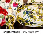 Small photo of Close up. Decoration items (plate, saucer, gravy boat, bottle for "aceto" (vinegar) with lemon, leaves, olives. Traditional Italian ceramics. Sirmione. Lombardy. Italy. Perfectly hand-painted pottery.