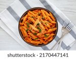 Small photo of Homemade Penne Alla Vodka from Leftover Sauce with Cheese and Parsley, top view. Overhead, from above, flat lay.