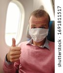 Small photo of selfie in a repatriation flight to Europe in a mask due to prevent getting coronavirous