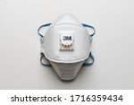 White FFP2, N95 respirator on a white table. Dust protection respirator or medical respiratory mask against the virus, top view.