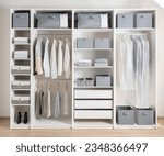 Small photo of Closet with different clothes and accessories, Clothing Cover in a modern white wardrobe Organizer inside a modern room