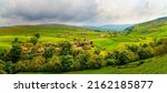 A village in a picturesque mountain valley. Valley village panorama. Village in valley panoramic landscape. Green valley panorama