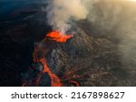 Burning lava erupts from a...