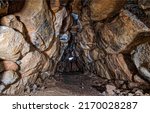 Tunnel cave of stones. Underground cave tunnel. Cave tunnel underground. Cave tunnel corridor underground
