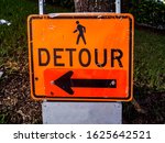 Orange detour sign with clip...