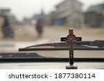 a small cross on the dashboard of the car to accompany the journey