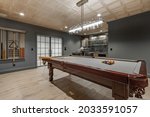 recreation room with large wooden pool table and glass doors