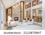 Small photo of Mid century craftsman house interior living room foyer home office with wood panel walls staircase creative wooden railings stone fireplace in warm white tones and orange accent colors