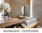 powder room with slatted wood walls orchid square sink and soft wood tones