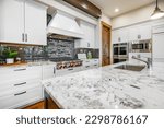 Home kitchen interior with island and bar stools hardwood floors granite and corion countertops white and wood tone cabinets large and spacious rooms