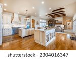 Small photo of Elegant french country style kitchen with blue cast iron oven marbled countertops soft yellow wood cupboards gleaming hardwood floors