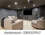 interior media room with dark grey walls comfortable furniture and large tv screen
