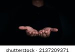 Small photo of Give two hands with nothing on both on dark background with copy space. Close-up receiving gesture of outstretched cupped empty open hands. Concept of giving, donation, receiving, asking, and bribery.