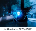Small photo of Cybersecure, worldwide internet network security technology, privacy digital data protection concepts. Safety shield icon hologram appears while person work with digital tablet computer, blue tone.