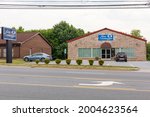 Small photo of HICKORY, NC, USA-7 JULY 2021: Fine Consign, a consignment shop of upscale used furniture. Building front, parking lot and signs.