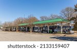 Small photo of GASTONIA, NC, USA-3 MARCH 2022: City bus terminal, showing several buses lined up waiting for departure time. People on benches waiting.