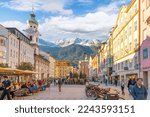 Small photo of Innsbruck, Austria - November 22 2022: The main square in the city of Innsbruck, as tourists enjoy shops and cafes with the baroque Hospital Church and the snow covered Austrian Alps as a backdrop.