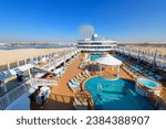Small photo of Suez Canal, Egypt - January 8 2023: A large cruise ship passes through the Suez Canal an artificial sea-level waterway connecting the Mediterranean Sea to the Red Sea dividing Africa and Asia.