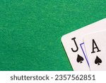 Small photo of Jack of Spades and Ace of Spades or Blackjack on a green background