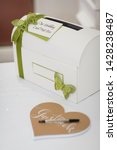 Small photo of Wedding Card Gift Post Box and Guestbook on Table in Wedding Reception