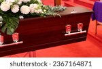 Small photo of closeup shot of a funeral casket or coffin in a hearse or chapel or burial at cemetery