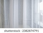 Small photo of White chiffon curtains for interior design decoration. Modern lifestyle background and texture. Satin sheer curtains with morning sunlight