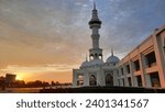 Small photo of Sunset over a mosque Sultan Mahmud Riayat Syah in Batam, Indonesia.