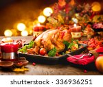 Roasted Turkey. Thanksgiving table served with turkey, decorated with bright autumn leaves and candles. Roasted chicken, table setting. Christmas dinner 