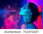 High Fashion model woman in colorful bright lights posing, portrait of beautiful  girl with trendy make-up. Art design, colorful make up. Over colourful vivid background. 