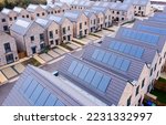 Small photo of Aerial view of rows of new build modular terraced houses in the UK with characterless design for first time buyers