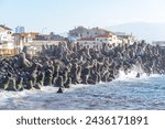 Small photo of coast facing the Atlantic Ocean with breakwater barriers built by countless concrete tetrapods.ponta delgada-sao miguel-acores-portugal.10-03-2024