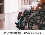 Small photo of Asian special child on wheelchair is have intention with using smart phone alone in bedroom background,Real people's pictures of daily life in the home,Life in the education age of disabled children.