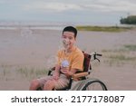 Blur of young man with disability playing bubble shooter toy gun.A practice of using hand and finger muscles through play.One form of occupational therapy practice that develops good emotional skills.