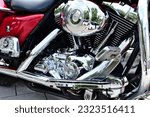 Small photo of Budapest, Hungary-06.23.2023: powerful Harley Davidson motorcycle engine block closeup. reflective shiny chrome finish. V engine. stainless exhaust pipes and crash guard bars. engineering and design