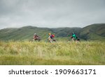 Small photo of Three people cycling the Otago Central Rail Trail towards Middlemarch, South Island, New Zealand