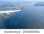 Small photo of Seattle, USA - Jul 30 2023: Southwest Airlines airplane flying towards Seattle. Aerial view of Seattle cityscape.