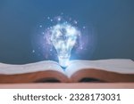 Small photo of the light bulb that glows on the book Offer inspiration from reading. innovative idea or knowledge of lifelong learning education