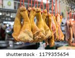 Small photo of Raw pork legs are hung with red ropes for sale on the marget
