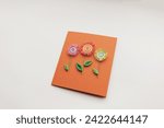 Small photo of quilling card with flowers. making greeting cards. Beautiful flowers designs. Paper quilling, colorful paper flowers. Hand made of paper quilling technique. Handicraft at home. Hobby, home office.