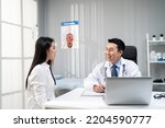 Small photo of Asian woman patient visit and consult health problem with young doctor. Attractive therapist practitioner work to explain diagnosis in office hospital to give treatment to sick girl during appointmen