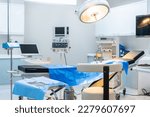 Small photo of Modern operating room with surgical instruments equipment and tool. Different surgical instruments preparing and lying on surgical table. Steel medical instruments ready to be used at medical hospital