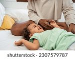 Small photo of African loving mom play with cute baby girl child on bed in bedroom. Happy family, attractive beautiful young mother ticklish on toddler daughter enjoying activity relationship in morning in house.