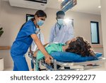 Small photo of Group of diverse doctors moving seriously injured patient in hospital. Attractive professional medic surgeon people in a hurry move emergency patient lying on a stretcher into operating theater room.