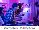 Small photo of Caucasian Esport couple gamer playing online video game on computer. Handsome man gaming player feel happy and excited, enjoy technology broadcast live streaming while plays cyber tournament at home