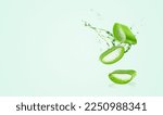 Small photo of Aloe Vera on green background. Leaf of Aloe Vera plant and splash of juice or gel. Natural essence for herbal beauty products, cosmetology, dermatology, naturopathic medicine.