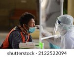 Small photo of Thailand : February 13, 2022 - Public health workers wearing PPE are providing Rapid antigen test services to people, using Kheha Thung Song Hong Wittaya School 2 Bangkok as an ad hoc service point.