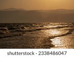 Golden hour sunset with wavy ocean in the city of Mersin, landscape photography