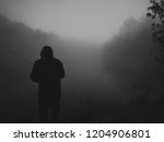 lonesome fisherman on the foggy ... | Shutterstock . vector #1204906801
